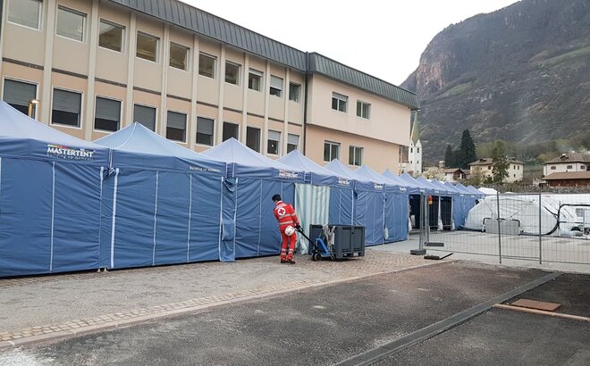Blue gazebo by Mastertent form a long corridor in front of the Bolzano hospital to fight the coronavirus.